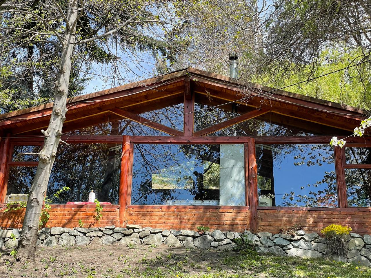 The glass-walled barbecue house among the trees